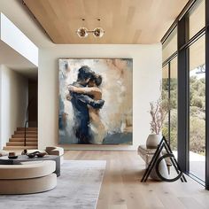 a living room with a large painting on the wall