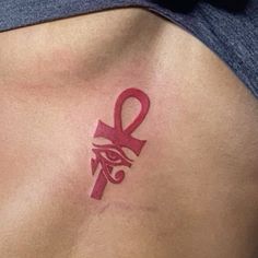 a close up of a person's stomach with an egyptian symbol on the side