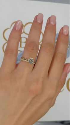 a woman's hand with a diamond ring on it