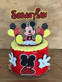 a mickey mouse birthday cake with the name sebastin on it and two ears