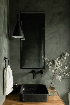 a bathroom sink sitting under a mirror next to a wooden counter