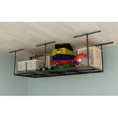 a toy train is on top of a shelf in a room with blue walls and white ceiling