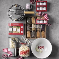 the popcorn box is filled with different types of snacks and candy bars, along with other holiday treats