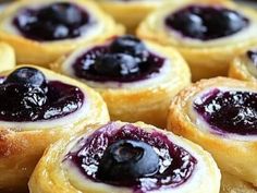 blueberry filled pastry rolls sitting on top of each other