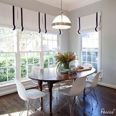 a dining room table surrounded by white chairs