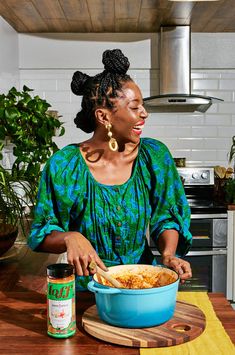 a woman sitting at a kitchen table with a bowl of food in front of her