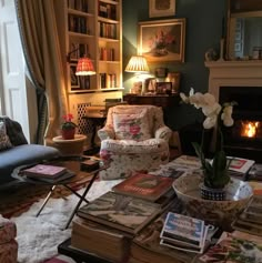 a living room filled with lots of furniture and books on top of a coffee table