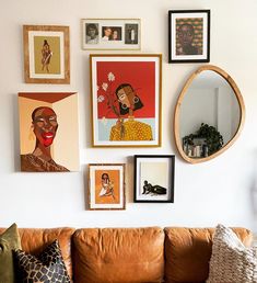 a living room filled with lots of pictures on the wall above a brown leather couch