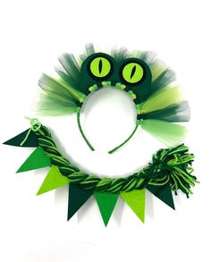 a green and white cat's headband with two eyes on top of it