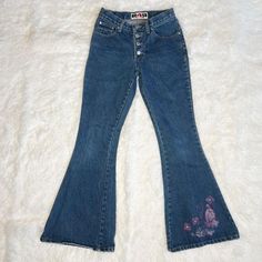 🦋Vintage 90s Raver Flare Bellbottom Butterfly Jeans🦋 The 90's are calling and they want their jeans back! These vintage Rave 4 Real denim flares bring a playful twist to a classic style. The dark-to-medium wash is accented with a pink butterfly and floral print at the hem, adding a touch of femininity. With a lower rise, snug fit through the hips, 4-button fly closure, and a flare that starts just above the knee, these jeans sculpt a silhouette that's both nostalgic and fashion-forward.  Overall very good pre-loved condition. Two small spots starting to fray on one leg and a very small hole right next to the lower most button closure. Easy mend for someone that sews.  Era: 1990s Vintage Brand: Rave 4 Real Color: Classic Denim Blue *Material & Size tags not present. Best fits Junior's 7/9 Retro Denim Flares For Spring, Spring Medium Wash Retro Flares, Spring Retro Medium Wash Flares, Spring Retro Denim Flares, Spring Retro Mid-rise Flares, Retro Flare Jeans For Spring Streetwear, Y2k High Rise Cotton Flare Jeans, Vintage Streetwear Bottoms For Spring, Retro Flares For Fall