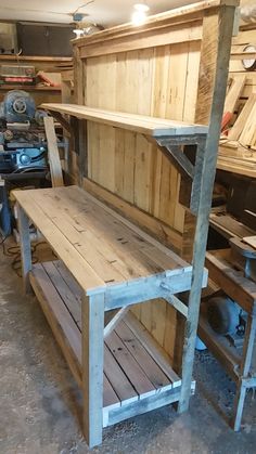 a wooden bench sitting inside of a garage