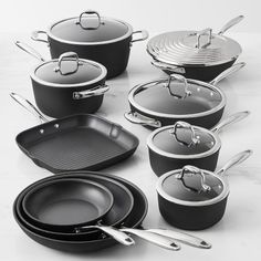 an assortment of pots and pans on a table