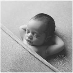 a black and white photo of a sleeping baby