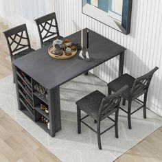 a dining room table with chairs and a wine rack on the floor next to it