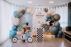 a room filled with balloons and decorations for a baby's first year birthday party