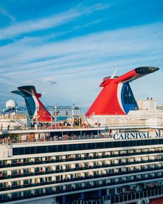 a large cruise ship docked at the dock with other boats in the water behind it