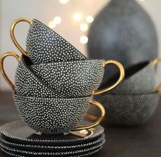 a stack of black and white cups sitting next to each other on top of a table