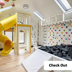 a play room with a slide and climbing wall in the background that says check out