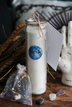 a glass jar filled with white liquid next to rocks