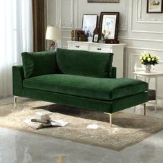 a green couch sitting on top of a rug in a living room