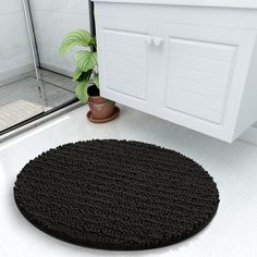 there is a black rug in the bathroom