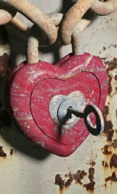 a red heart shaped padlock attached to a chain