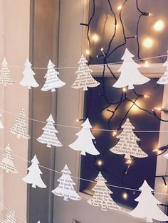 paper christmas trees are strung with string lights