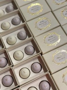 many different types of chocolates in boxes with gold trimming on the top and bottom