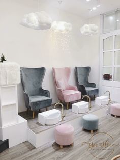 the salon is decorated in pastel colors and features modern chairs, stools, and footstools