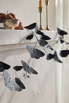 a white mantle with black butterflies hanging from it