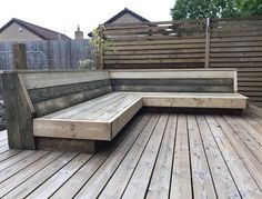 a wooden bench sitting on top of a wooden deck