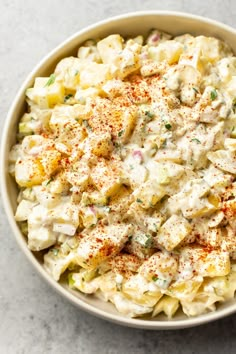 a bowl filled with macaroni salad on top of a table