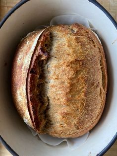 a loaf of bread sitting in a bowl on top of a table