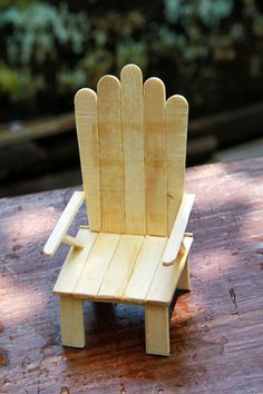 a wooden chair sitting on top of a wooden table