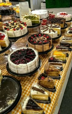 a table topped with lots of cakes and pies on top of plates next to each other