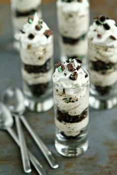 small desserts in glass cups with spoons on the side