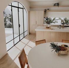 a kitchen and dining area with large windows