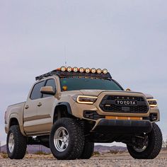 a truck with lights on it parked in the desert