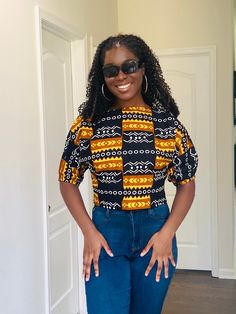 Add glam to your looks in this gorgeous, chic and flirty Ankara top.  Top is crop top style  Sleeves has comfortable elastic band.  Top has a Zipper on the side very comfortable fit Pair top with skirts, jeans or shorts . Model is 5.10 Inches tall Perfect gift for her Ankara Tops With Jeans, Ankara Crop Top, African Blouses, African Tops, Crop Top Style, Ankara Tops, Style Crop Top, African Clothes, Skirts Jeans