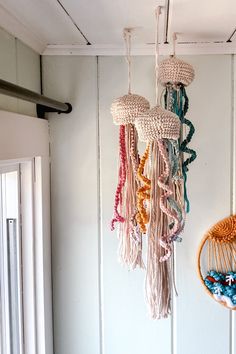 there are many different items hanging from the ceiling in this room, and one is made out of yarn