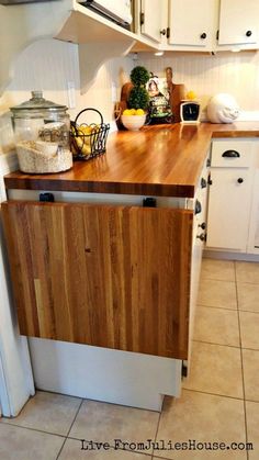 a wooden counter top sitting in the middle of a kitchen