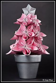 a pink origami christmas tree in a pot