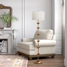 a living room filled with furniture and a fire place next to a mirror on the wall