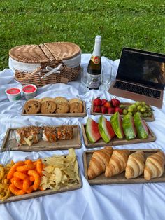 there are many different foods on the table and in front of it is a laptop