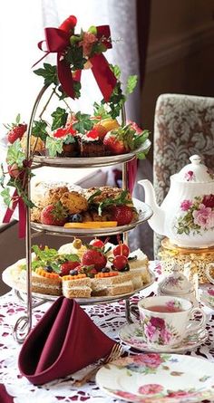 a table topped with three tiered trays filled with food