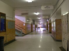 an empty hallway in a building with stairs