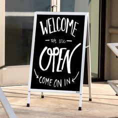 a black and white sign that reads welcome to the open come on in