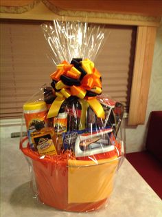 a basket filled with various items sitting on top of a white counter next to a window