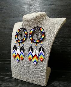 multicolored beaded earrings on a mannequin