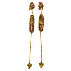 CHRISTIAN LACROIX vintage gold tone extra long dangling earrings (clip-on) embellished with an oval glass cabochon and enamel. Marked CHRISTIAN LACROIX CL Made in France. Indicative measurements : height approx. 14 cm (5.51 inches) / max. width approx 1.1 cm (0.43 inch). Weight per earring : approx. 12 grams. Material : Gold tone metal hardware / Glass. NOTES - This is a preloved vintage item, therefore it might have imperfections. - Colors may differ slightly from actual product appearance due Christian Lacroix, Dangling Earrings, Metal Hardware, Gold Tone Metal, Extra Long, Vintage Gold, Made In France, Yves Saint Laurent, Jewelry Earrings Dangle